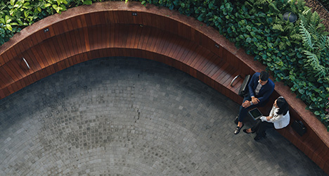 Couple talking on a brick bench